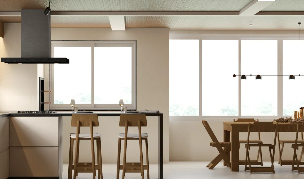 Cozinha com ilha em L, banquetas de madeira e mesa de jantar diante das janelas amplas